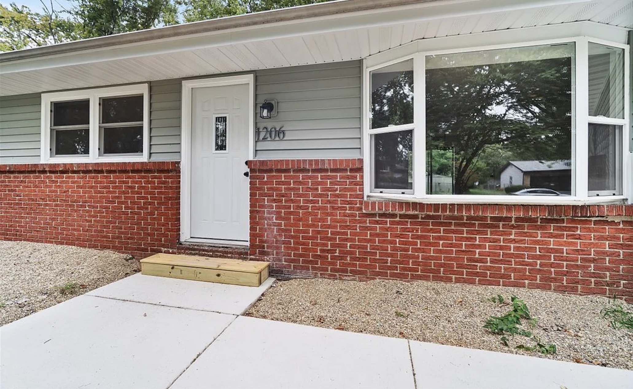 After: Renovated exterior at 1206 Townley Dr, Bloomington IL — new siding and windows