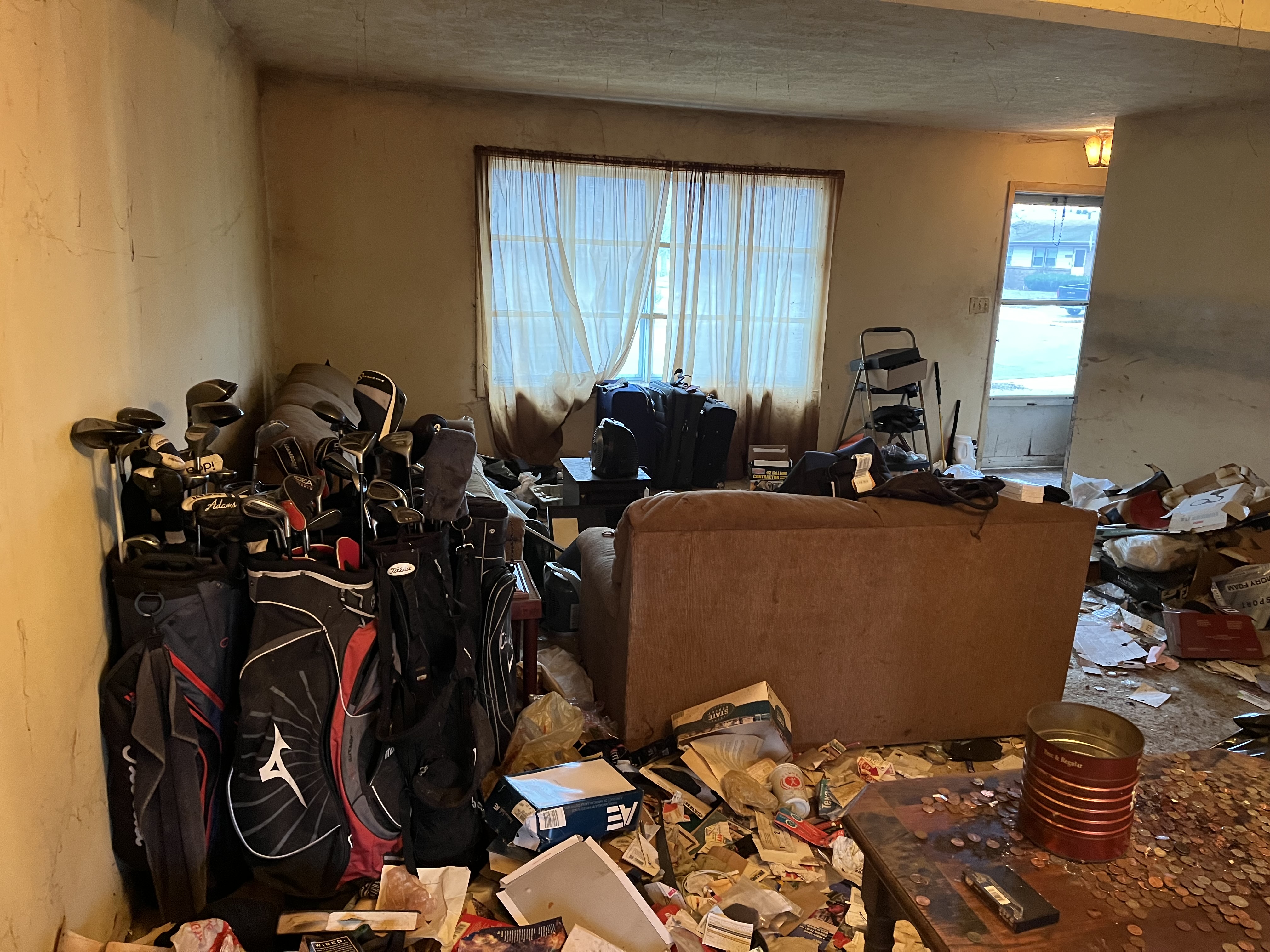 Before: Junk-filled living room at 1206 Townley Dr, Bloomington IL — inherited home