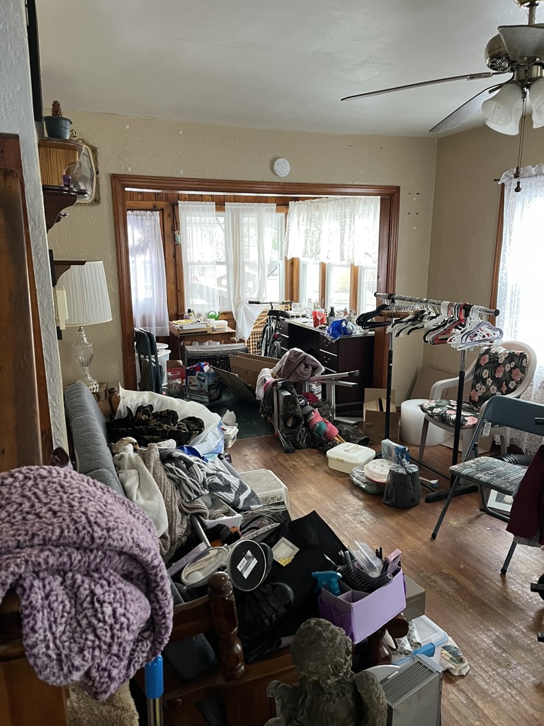 Before: Cluttered living room at 1213 S 9th St, Pekin IL — inherited home